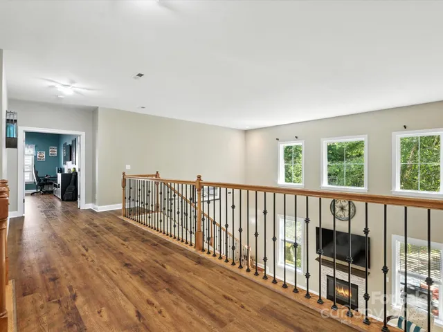 a room that has a dresser and a wooden floor