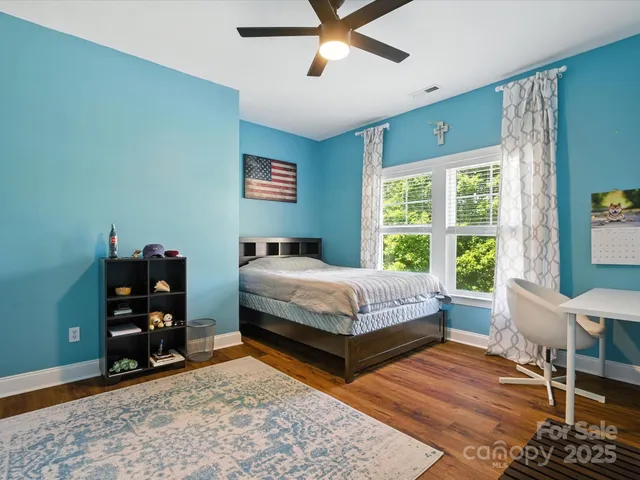 a view of a patio with table and chairs a fire pit and a large tree