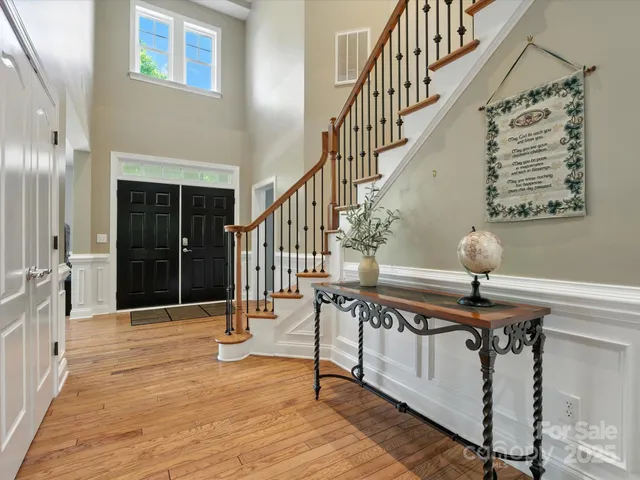 a view of entryway and hall with wooden floor