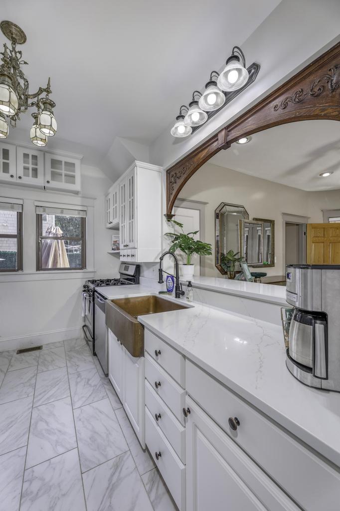507 Center Street Michigan City, IN 46360 - Photo 11 of 42 a spacious en suite bathroom with a granite countertop sink a large mirror and bathtub