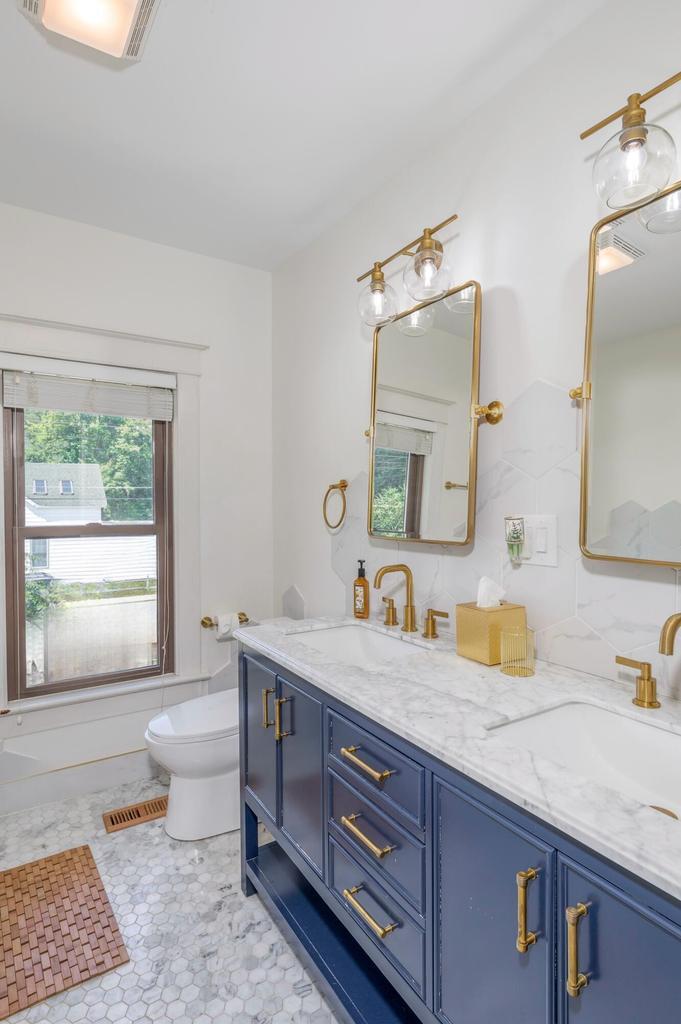 507 Center Street Michigan City, IN 46360 - Photo 26 of 42 a bathroom with a granite countertop sink and a large mirror