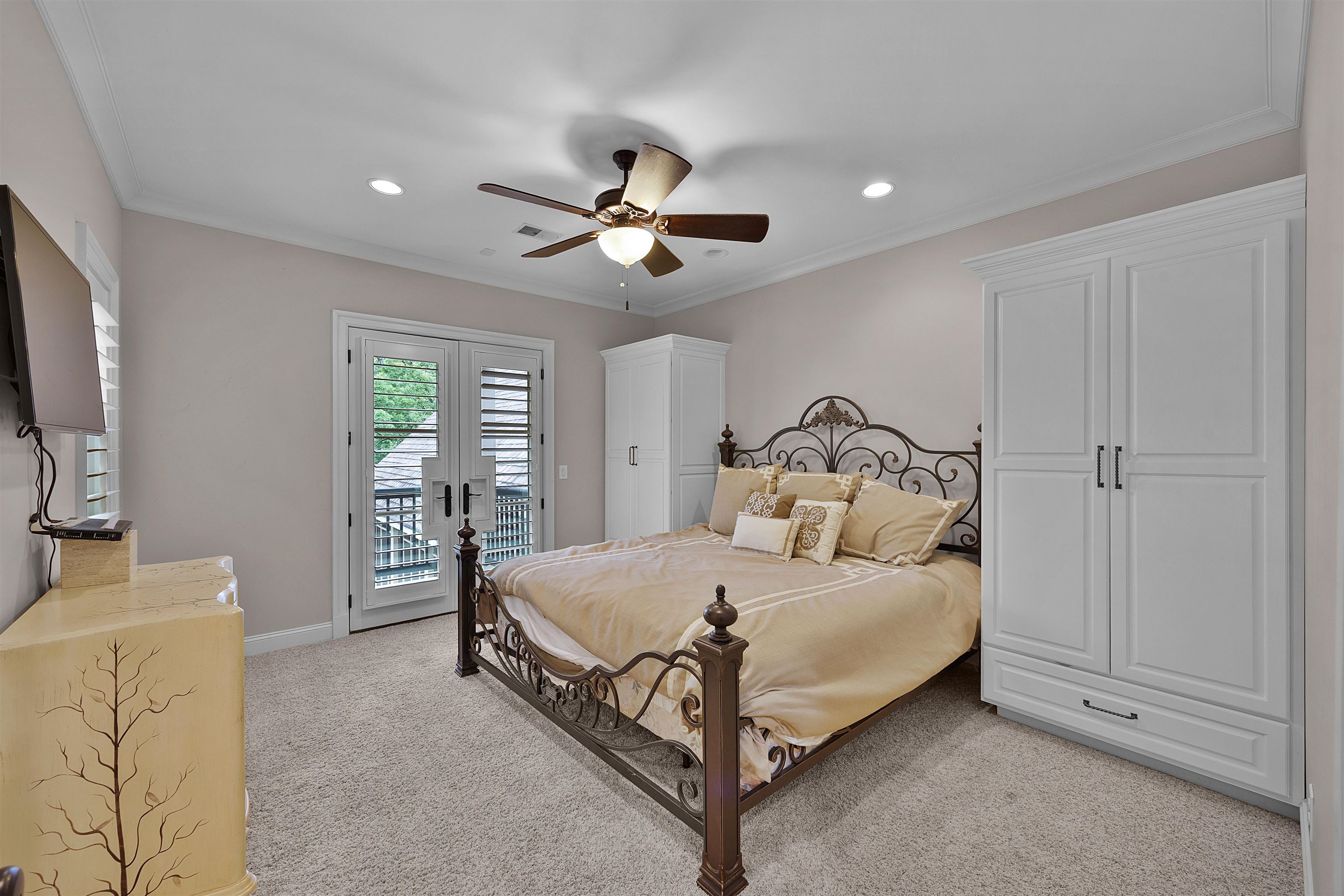 25 Caney Hollow Road Counce, TN 38326 - Photo 26 of 40 a bedroom with a bed and a flat tv screen on dresser