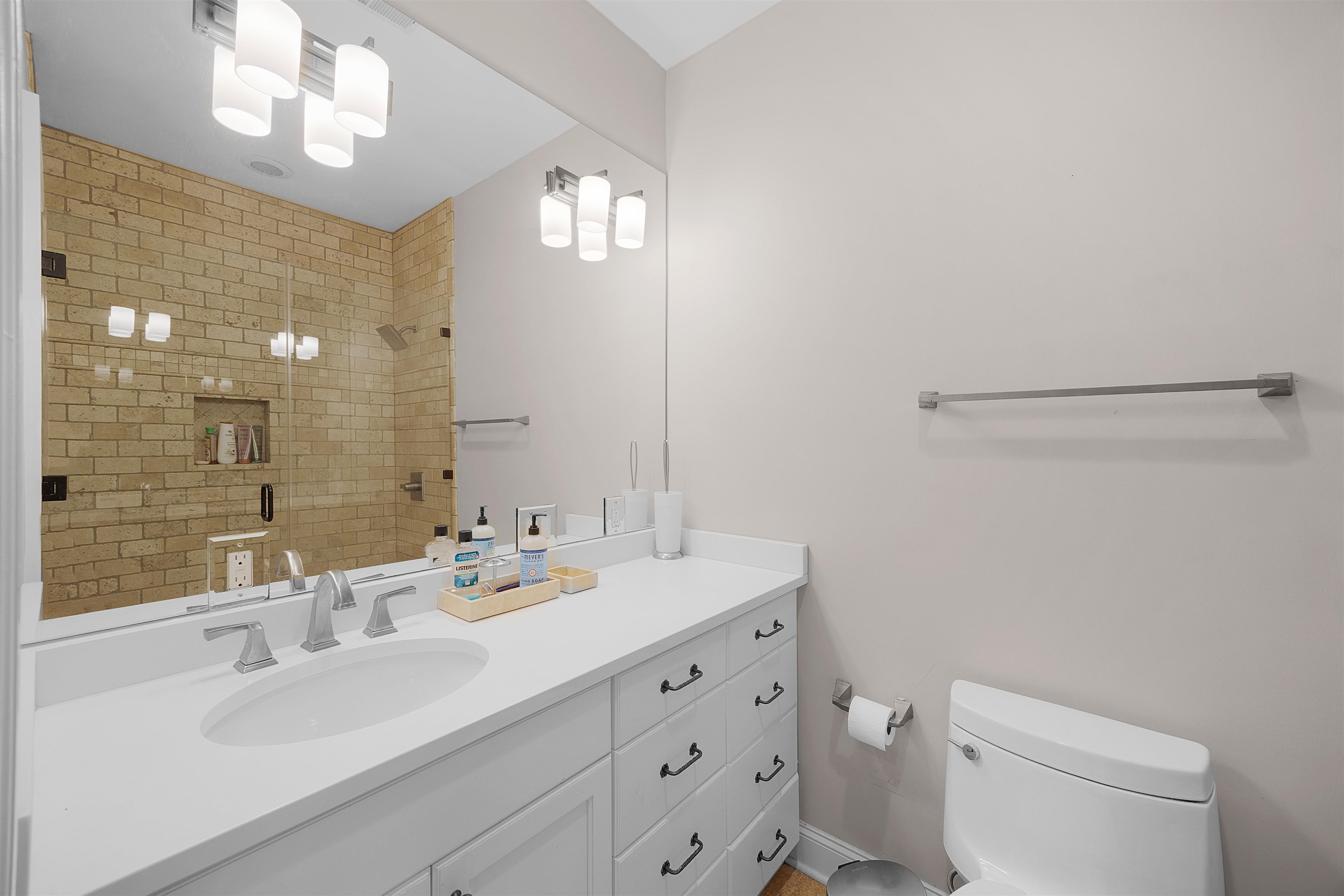 25 Caney Hollow Road Counce, TN 38326 - Photo 27 of 40 a bathroom with a sink a toilet and a large mirror