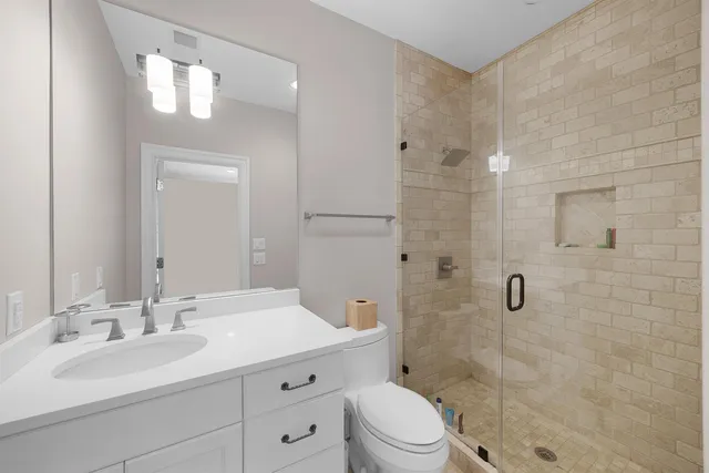 a spacious bedroom with a bed and a dresser