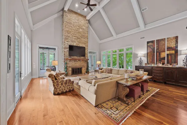 a living room with fireplace furniture and a wooden floor