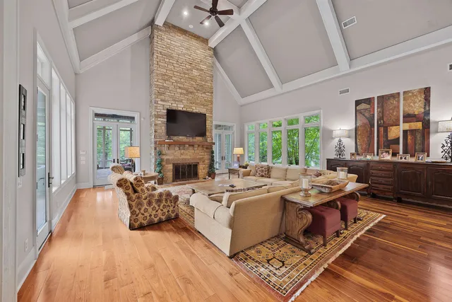 a living room with fireplace furniture and a wooden floor