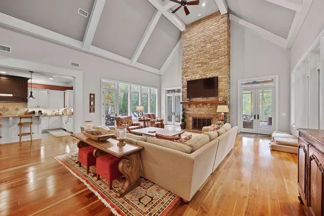 a living room with lots of furniture and wooden floor