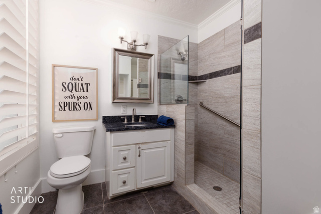 1331 South Lowry Hl Road Manti, UT 84642 - Photo 26 of 56 Bathroom with vanity, a walk in shower, crown molding, and dark tile patterned floors