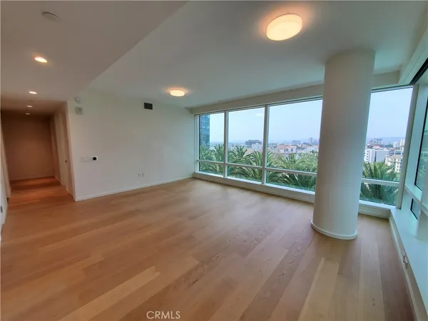 a view of a room with wooden floor and window