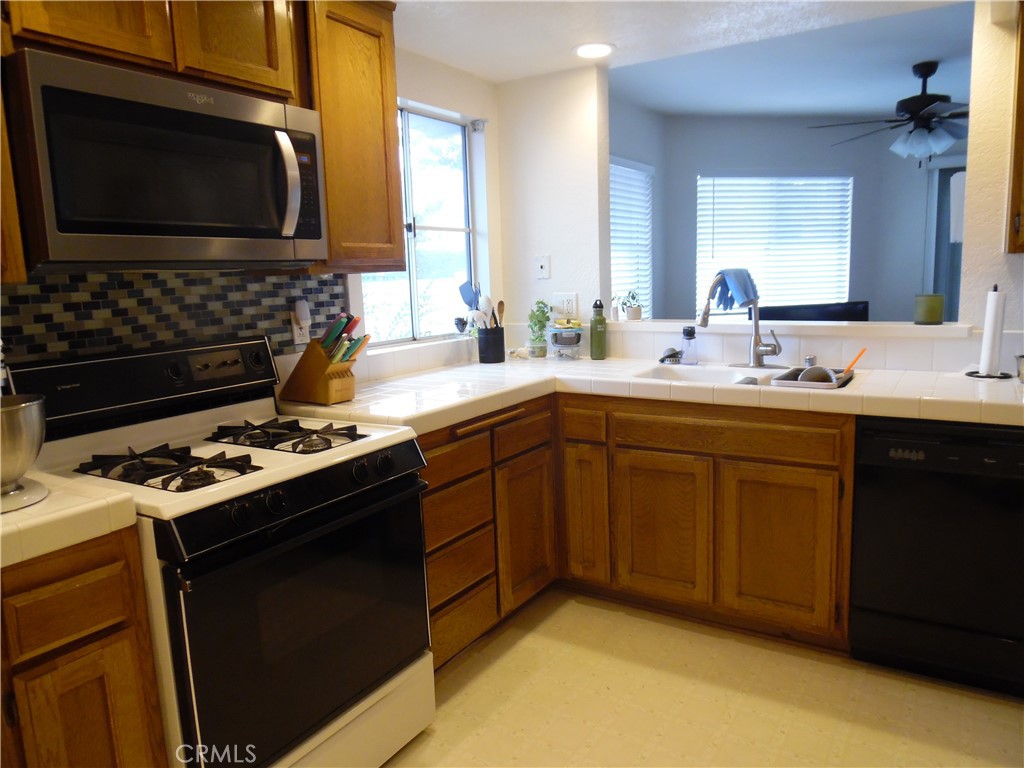 1806 Rory Lane, Unit 9 Simi Valley, CA 93063 - Photo 11 of 28 a kitchen with a sink stove and microwave