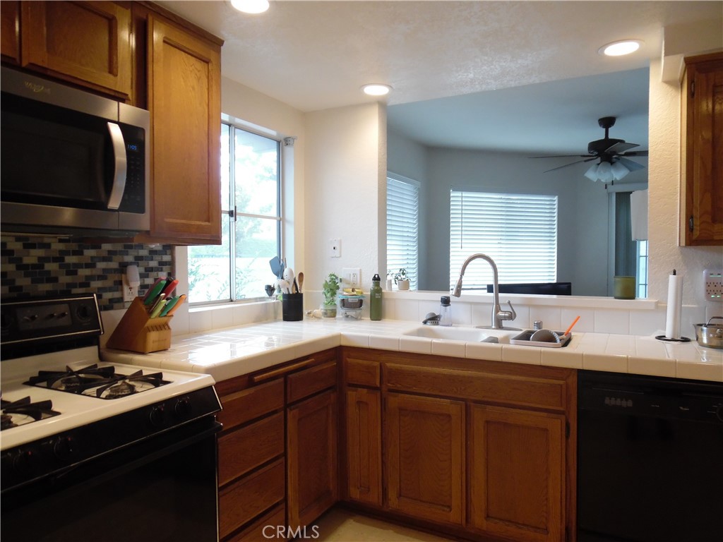 1806 Rory Lane, Unit 9 Simi Valley, CA 93063 - Photo 12 of 28 a kitchen with a sink stove top oven and cabinets