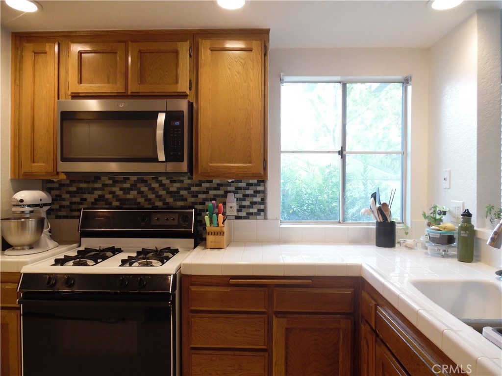 1806 Rory Lane, Unit 9 Simi Valley, CA 93063 - Photo 13 of 28 a kitchen with a stove a sink and a microwave