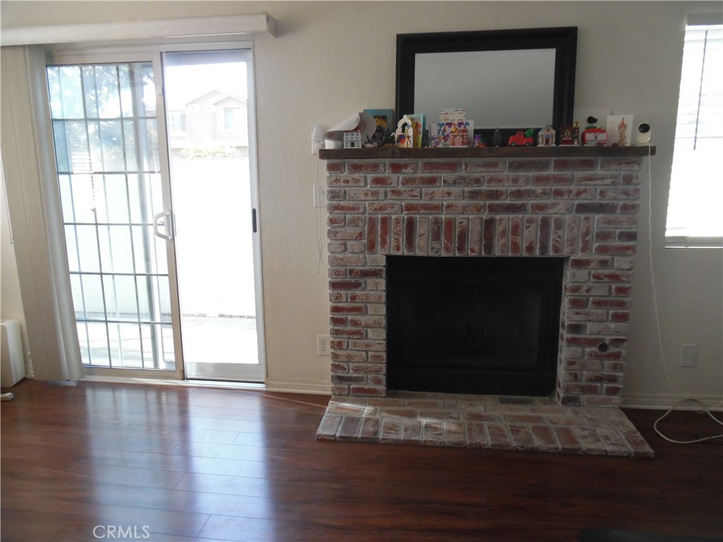 1806 Rory Lane, Unit 9 Simi Valley, CA 93063 - Photo 16 of 28 a living room with a fireplace and a wooden floor