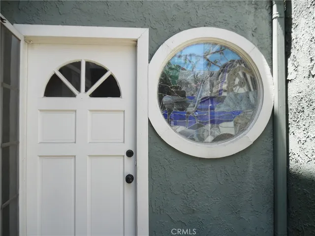 a view of staircase with railing and white walls