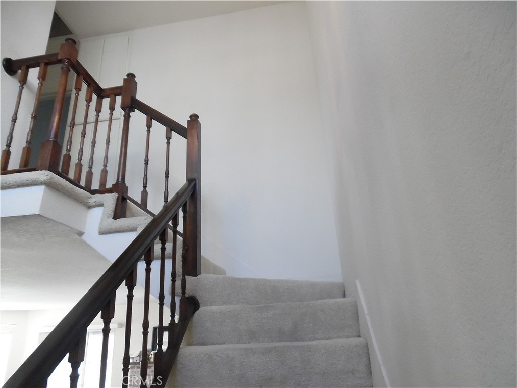 1806 Rory Lane, Unit 9 Simi Valley, CA 93063 - Photo 9 of 28 a view of staircase with railing and white walls