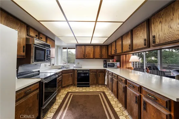 a kitchen with stainless steel appliances a stove a sink and a microwave