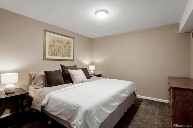 a bedroom with a bed and a night stand