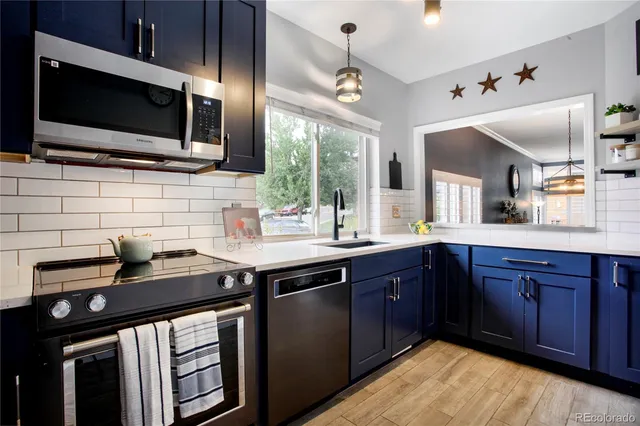 a kitchen with a sink stainless steel appliances and cabinets