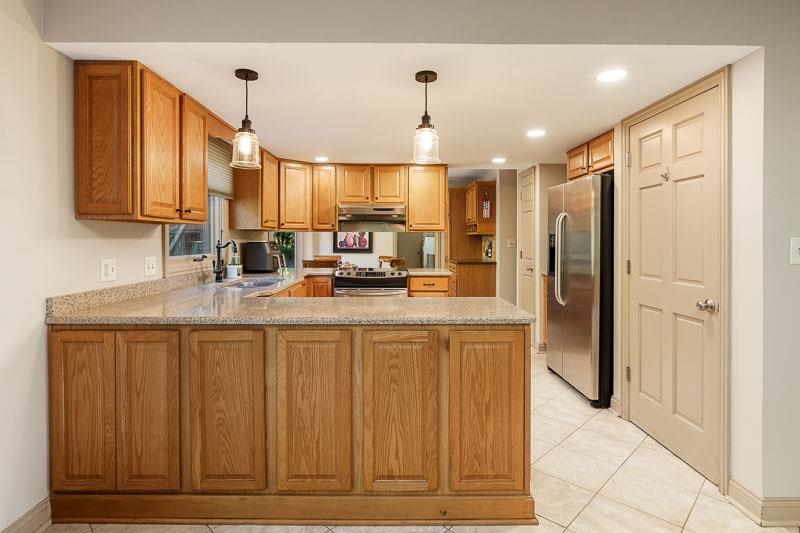 1753 Madron Road Rockford, IL 61107 - Photo 12 of 46 a kitchen with stainless steel appliances granite countertop a refrigerator and a sink