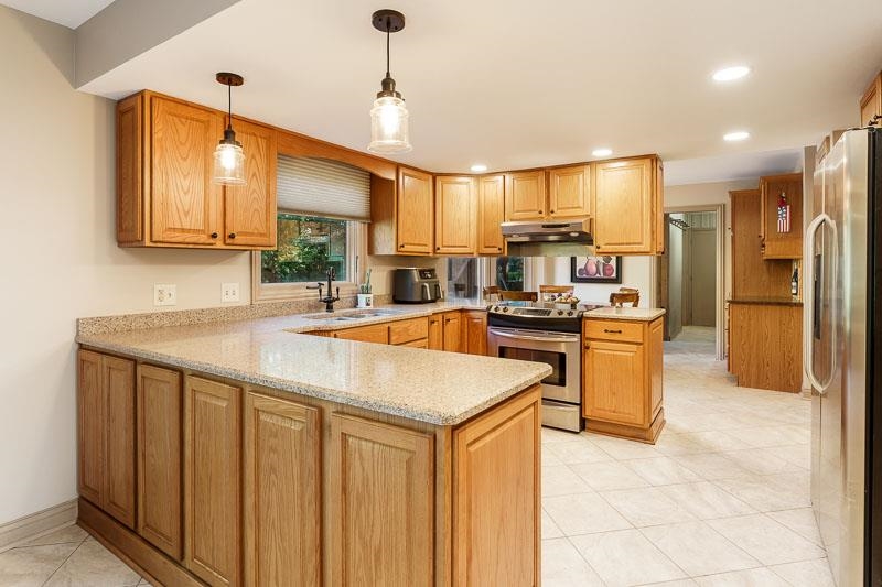1753 Madron Road Rockford, IL 61107 - Photo 13 of 46 a kitchen with stainless steel appliances granite countertop a sink a stove and refrigerator