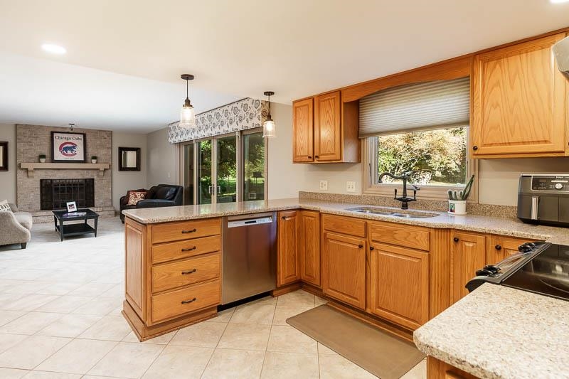1753 Madron Road Rockford, IL 61107 - Photo 14 of 46 a kitchen with granite countertop a stove top oven sink and cabinets
