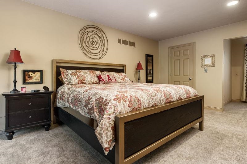 1753 Madron Road Rockford, IL 61107 - Photo 20 of 46 a bedroom with a bed and a lamp on dresser