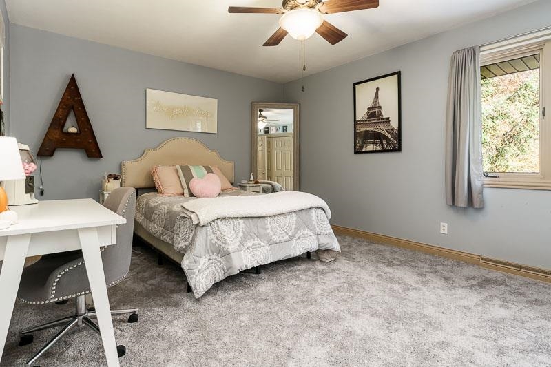 1753 Madron Road Rockford, IL 61107 - Photo 22 of 46 a bedroom with a bed and a chandelier