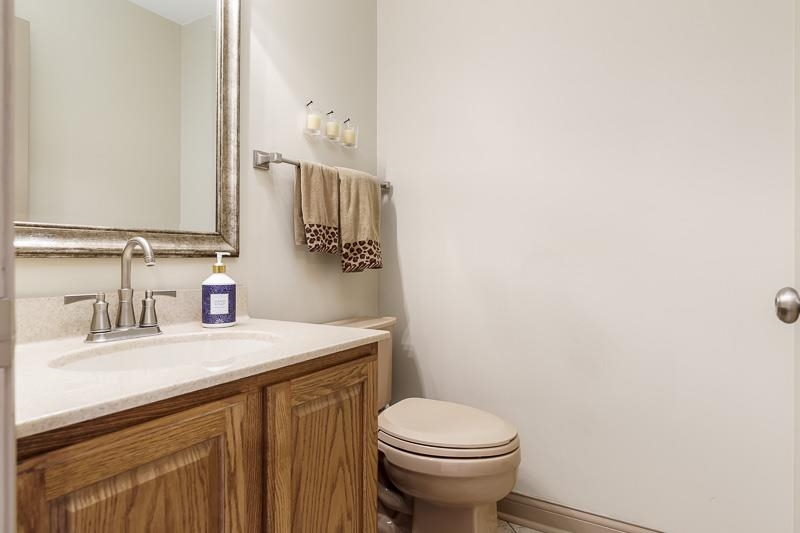 1753 Madron Road Rockford, IL 61107 - Photo 32 of 46 a bathroom with a sink a toilet and mirror