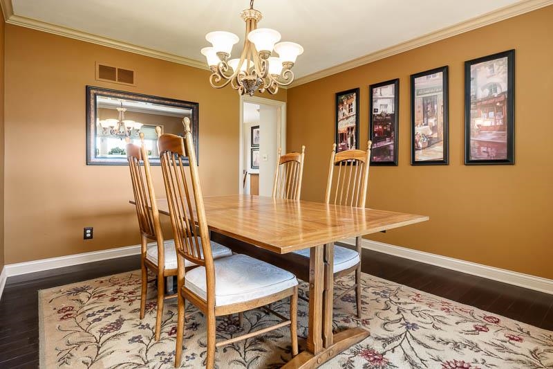 1753 Madron Road Rockford, IL 61107 - Photo 8 of 46 a dining room with wooden floor and a chandelier