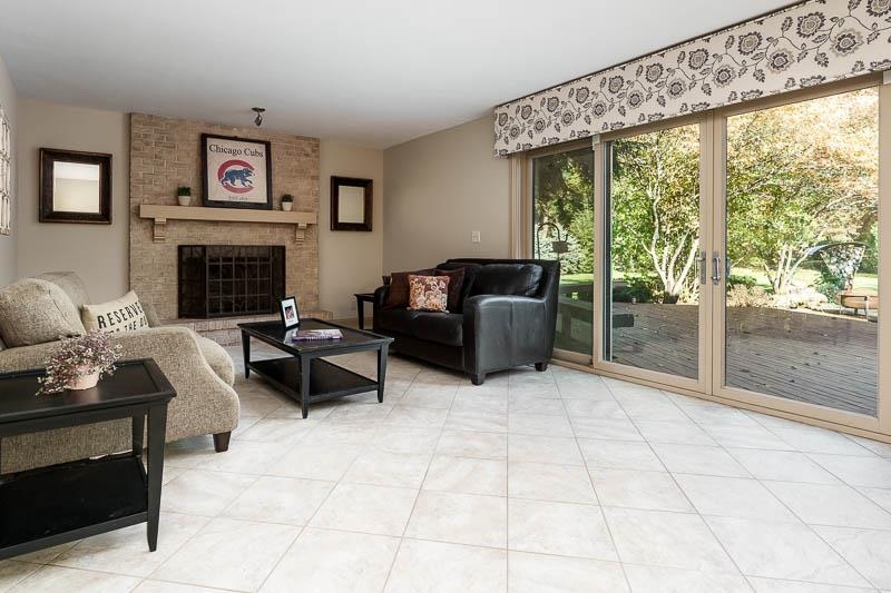1753 Madron Road Rockford, IL 61107 - Photo 9 of 46 a living room with furniture a fireplace and a floor to ceiling window
