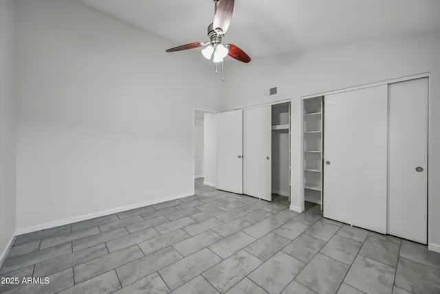 a view of an empty room with a fan