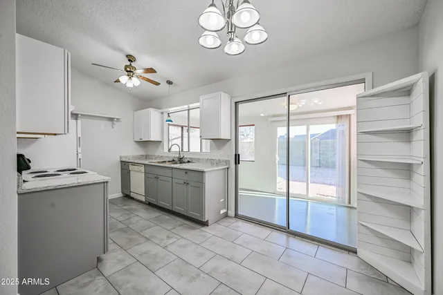 a kitchen with a stove a sink and a refrigerator