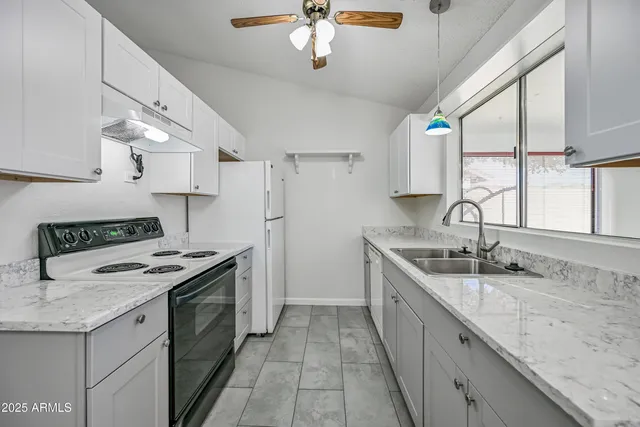a kitchen with a sink stove and cabinets