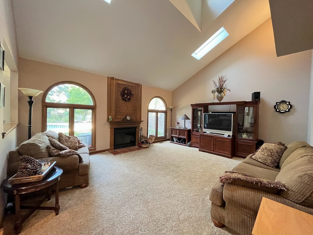 923 Parkside Road Naperville, IL 60540 - Photo 19 of 25 a living room with furniture a fireplace and a large window