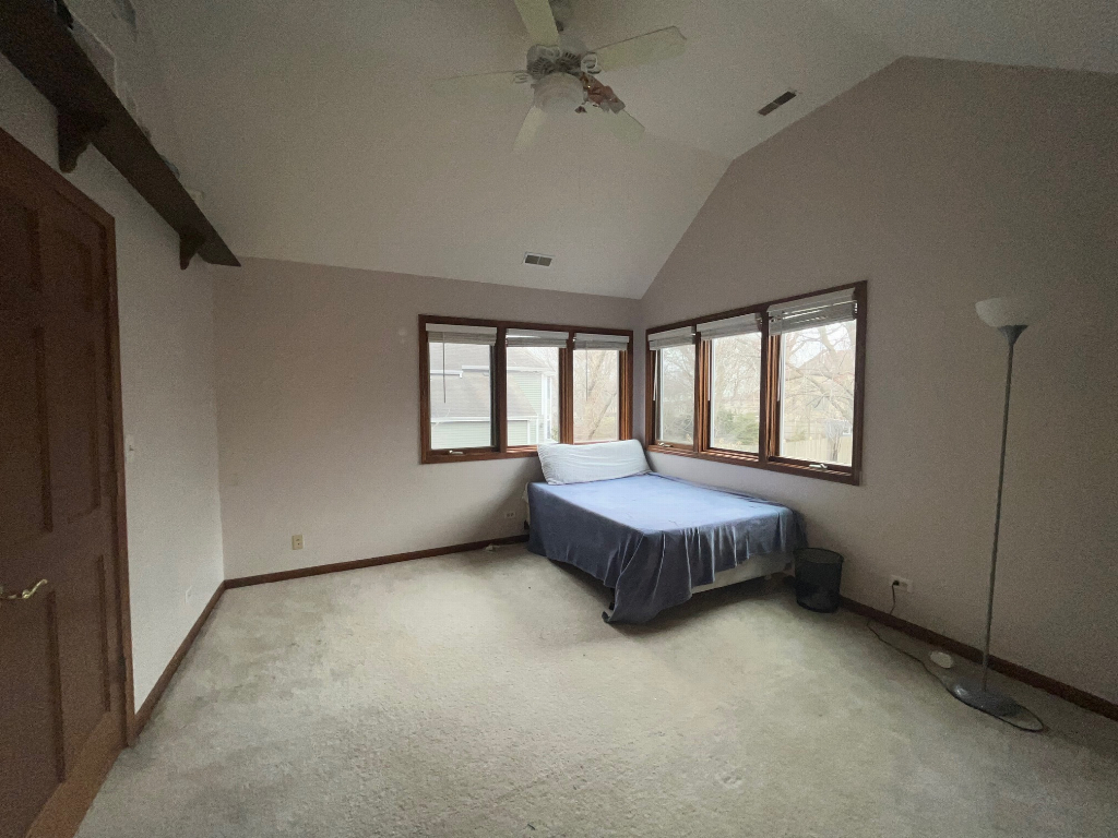 923 Parkside Road Naperville, IL 60540 - Photo 23 of 25 a spacious bedroom with a bed and a window