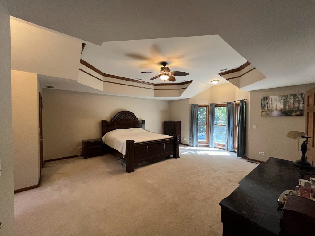 923 Parkside Road Naperville, IL 60540 - Photo 25 of 25 a bedroom with a bed and a chandelier