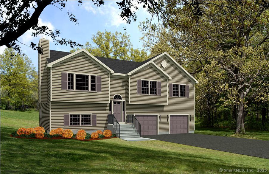 a front view of a house with a yard and trees