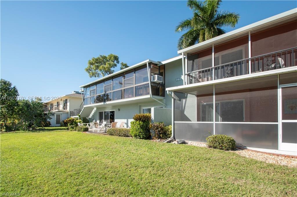 162 Teryl Road, Unit 62 Naples, FL 34112 - Photo 10 of 13 a backyard of a house with lots of green space and fountain