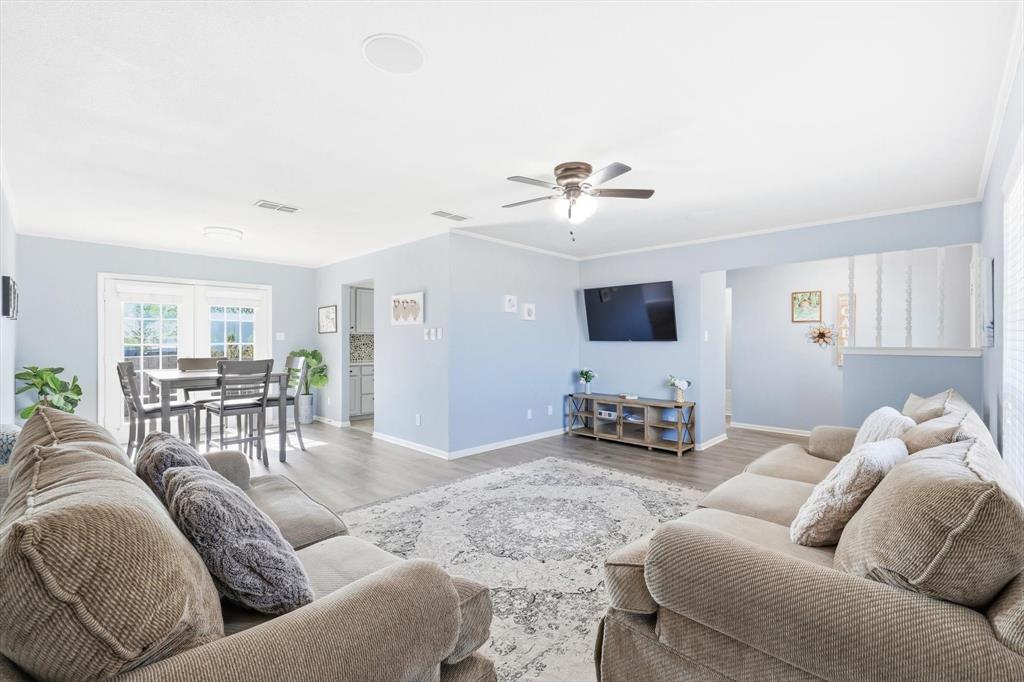3873 Lois Road East Sanger, TX 76266 - Photo 13 of 40 Large furnished living space with ceiling fan, new flooring and plenty of space!