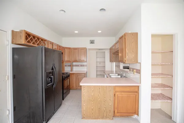 a kitchen with stainless steel appliances granite countertop a refrigerator and a sink