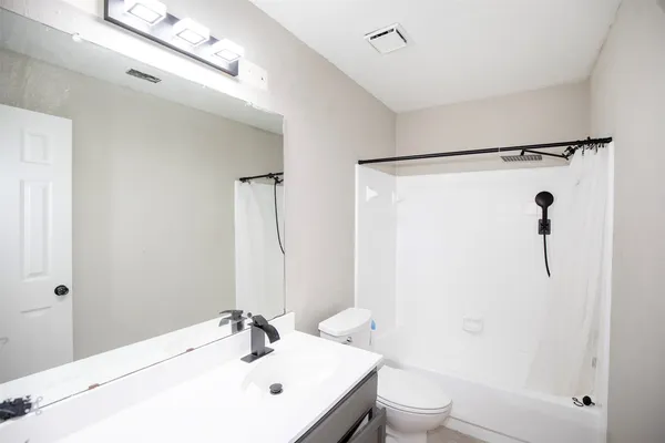 a bathroom with a sink toilet and shower