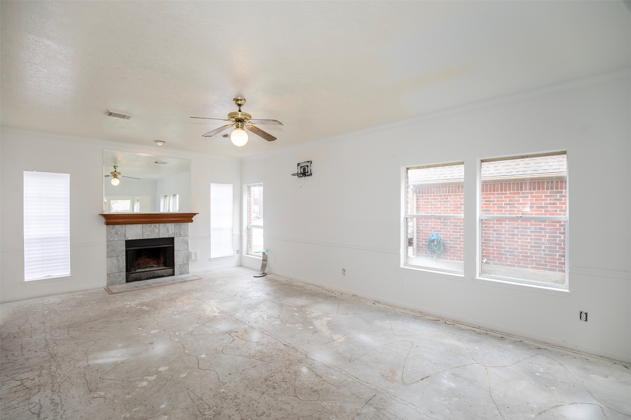 1627 Mabry Mill Road Houston, TX 77062 - Photo 7 of 32 an empty room with windows and fireplace