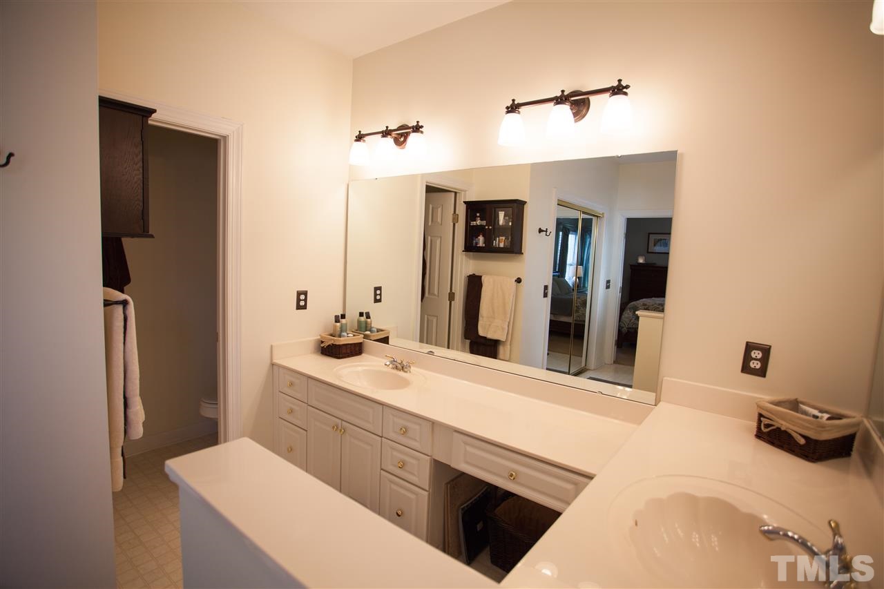8820 Braceridge Road Raleigh, NC 27613 - Photo 13 of 22 a bathroom with a sink and a mirror