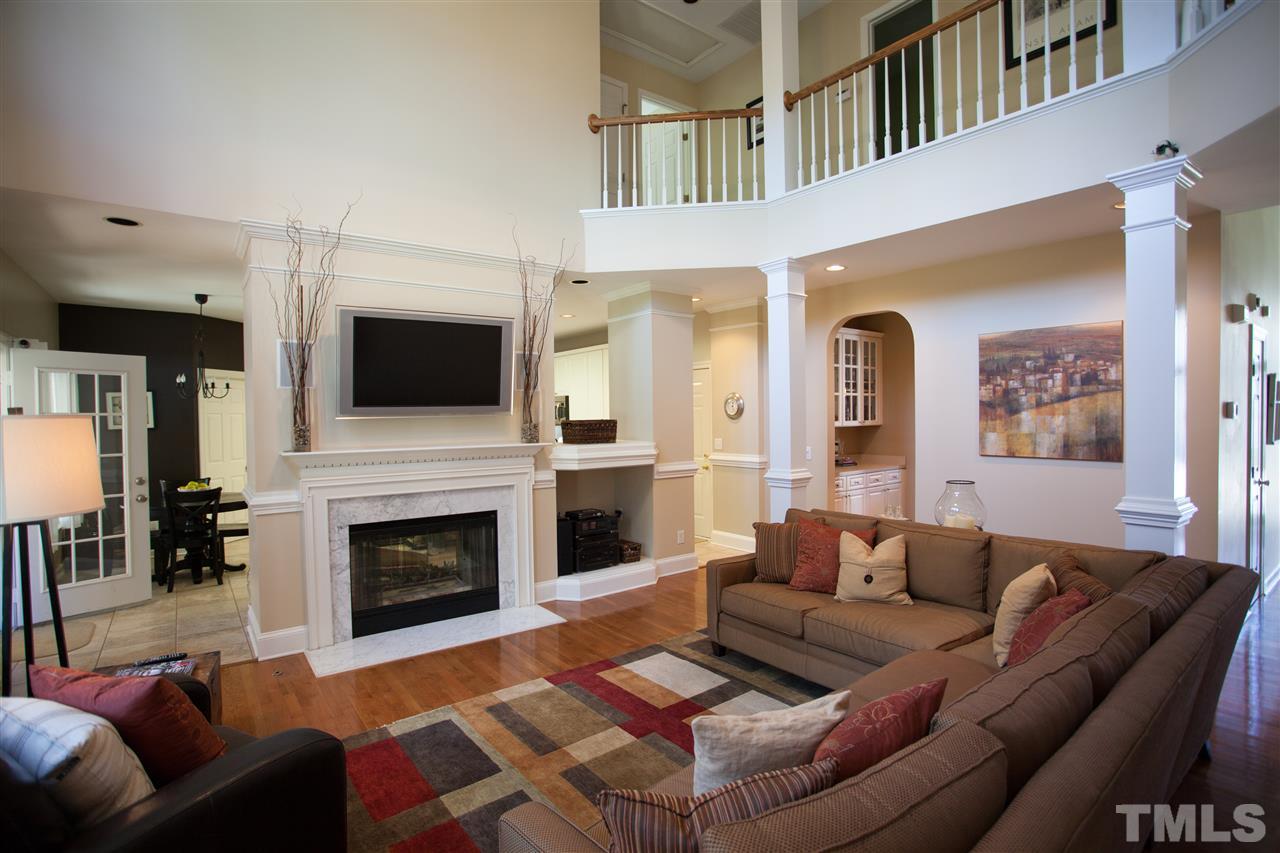 8820 Braceridge Road Raleigh, NC 27613 - Photo 5 of 22 a living room with furniture a flat screen tv and a fireplace