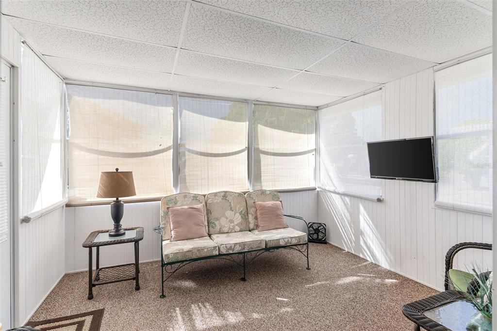 1610 Reynolds Road, Unit 98 Lakeland, FL 33801 - Photo 16 of 36 a living room with furniture a flat screen tv and a window