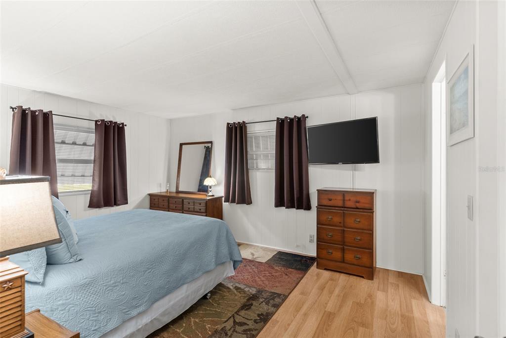 1610 Reynolds Road, Unit 98 Lakeland, FL 33801 - Photo 18 of 36 a bedroom with a bed and flat screen tv