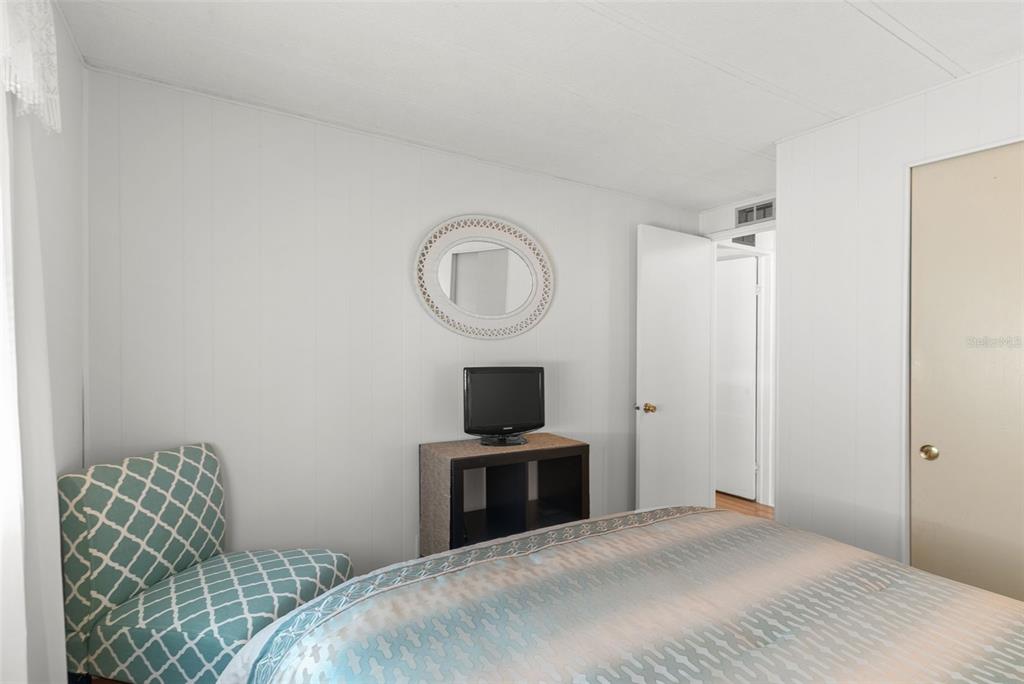 1610 Reynolds Road, Unit 98 Lakeland, FL 33801 - Photo 24 of 36 a bedroom with a bed and a chair