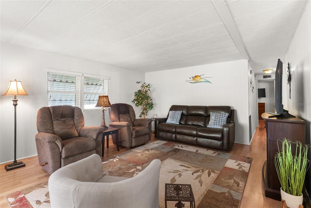 1610 Reynolds Road, Unit 98 Lakeland, FL 33801 - Photo 7 of 36 a living room with furniture and a flat screen tv