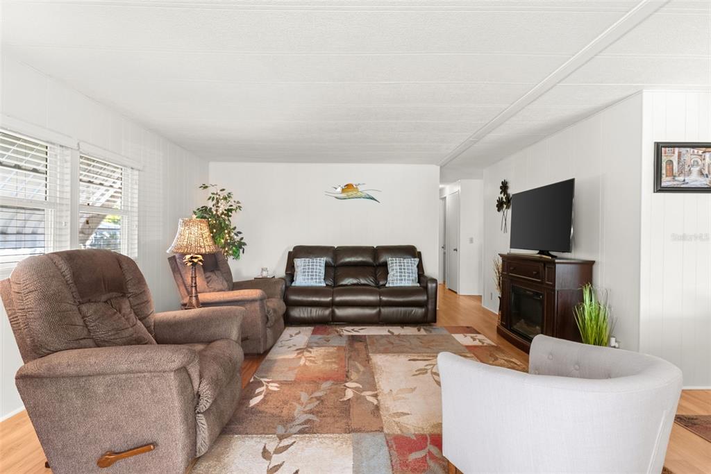 1610 Reynolds Road, Unit 98 Lakeland, FL 33801 - Photo 8 of 36 a living room with furniture and a flat screen tv