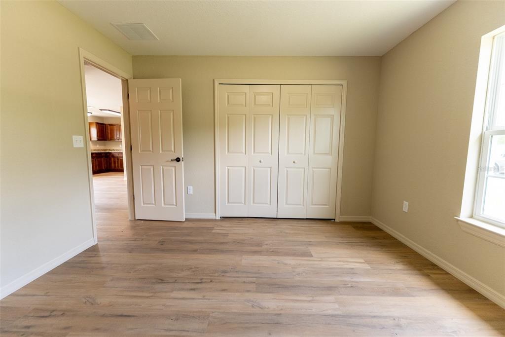 20 Willow Road Ocala, FL 34472 - Photo 20 of 28 a view of an empty room with wooden floor and a window